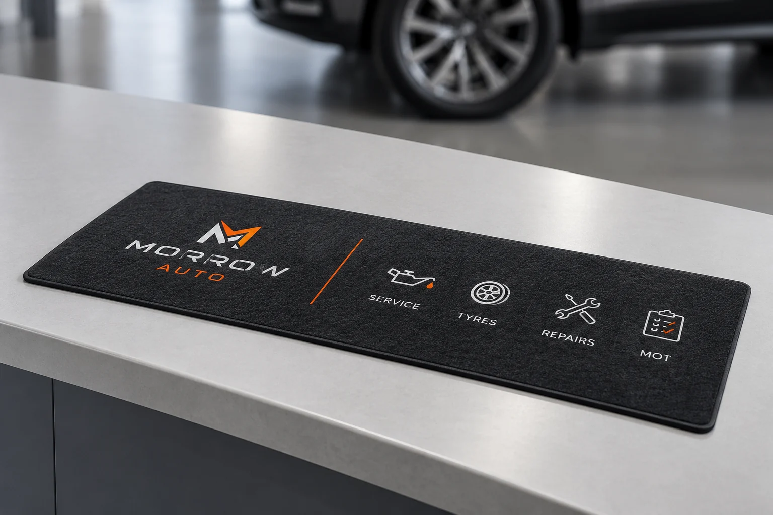 Illustrative mockup: a charcoal and orange service counter mat at an uncluttered auto counter