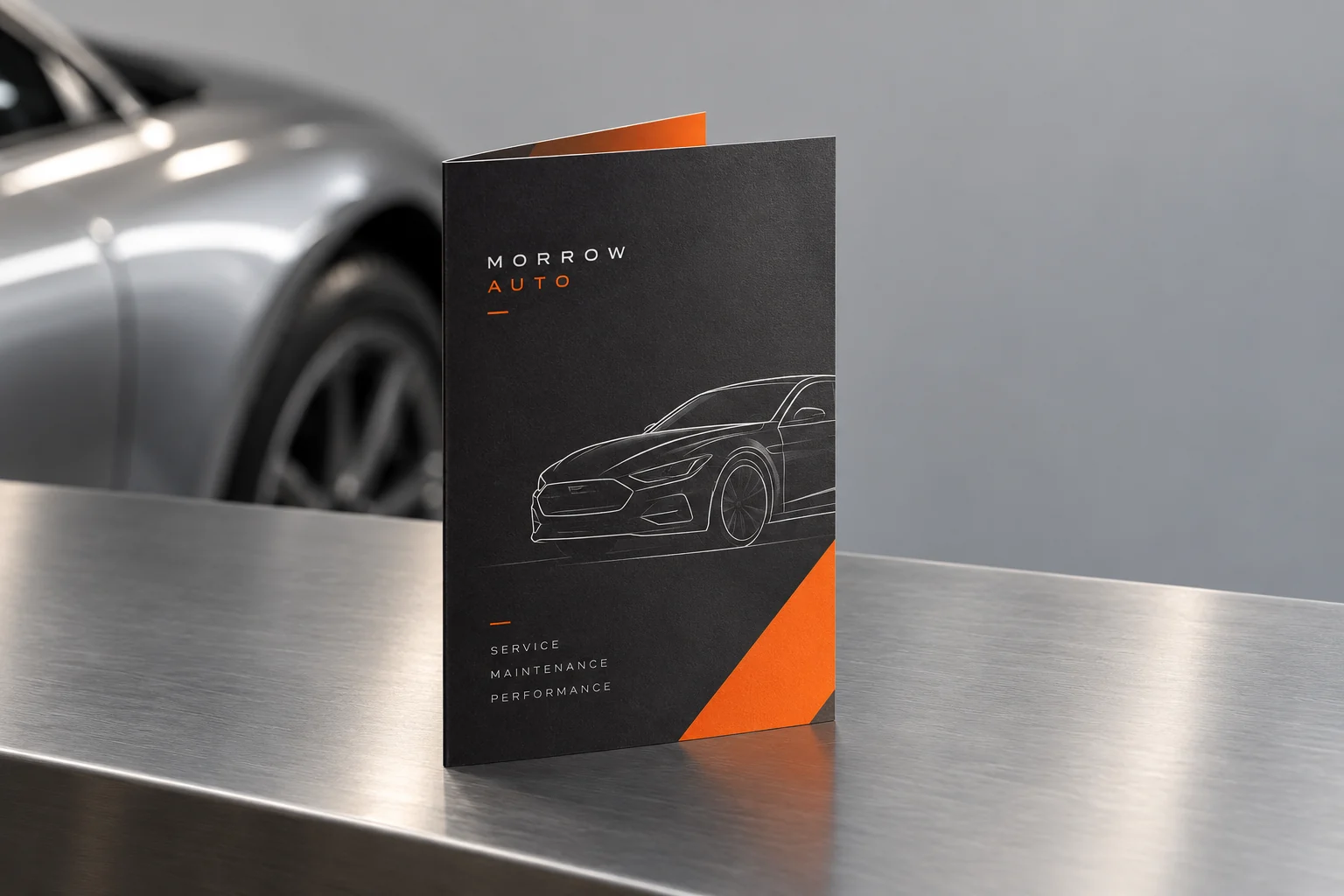 Illustrative mockup: a single automotive service brochure with a softly blurred silver car behind it