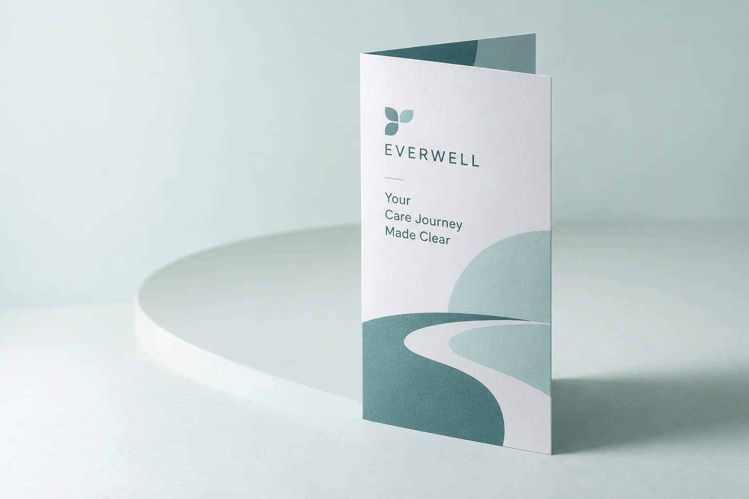 Illustrative mockup: one teal patient information brochure on a pale mint studio surface