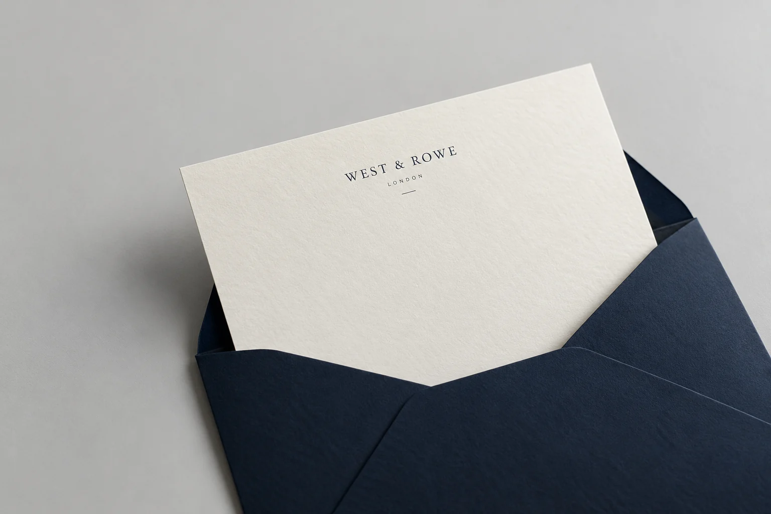 Illustrative mockup: ivory law firm letterhead partially withdrawn from an envelope on a cool gray surface